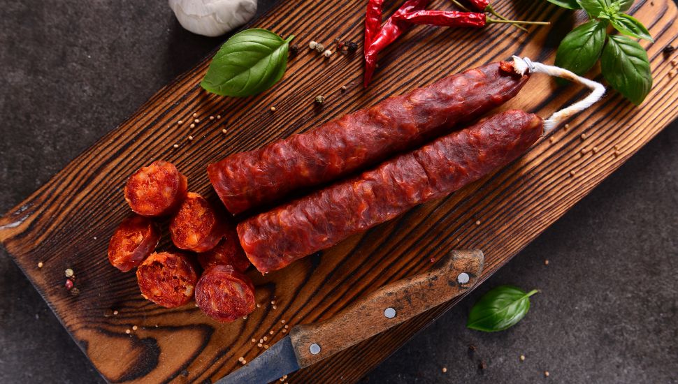 Chorizo on wooden cutting board with knife