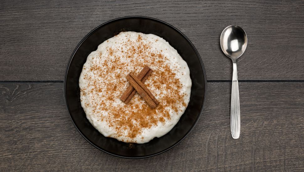 image of a bowl of Rice Pudding and a spoon