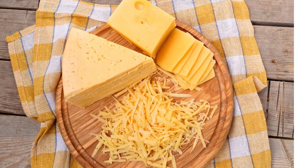 Big Cheese Pieces On A Wooden Plate