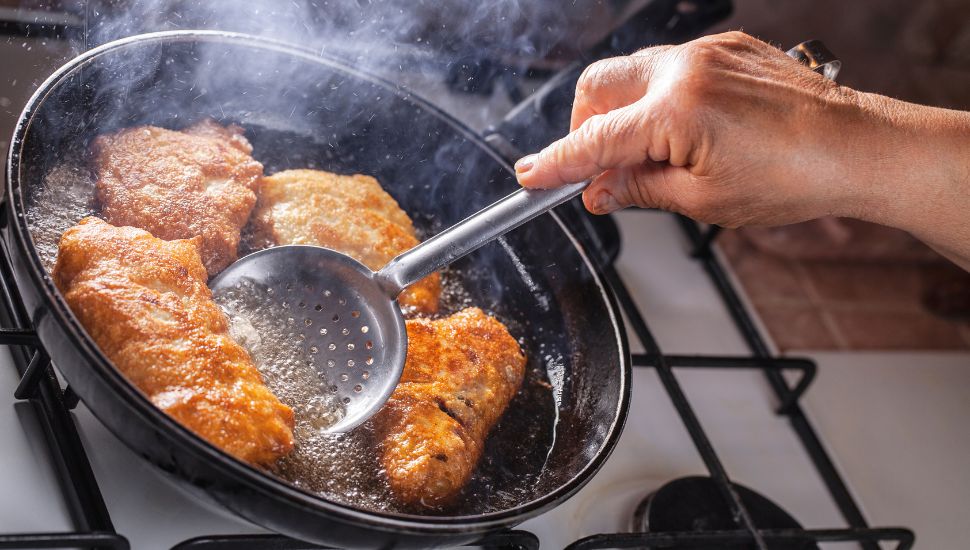 Frying chicken in a frying pan