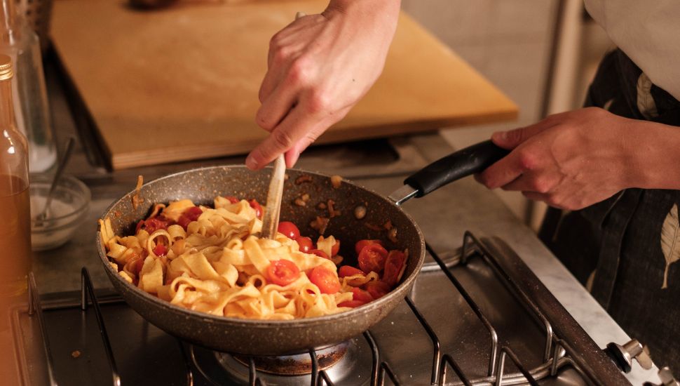 Image of a person cooking pasta