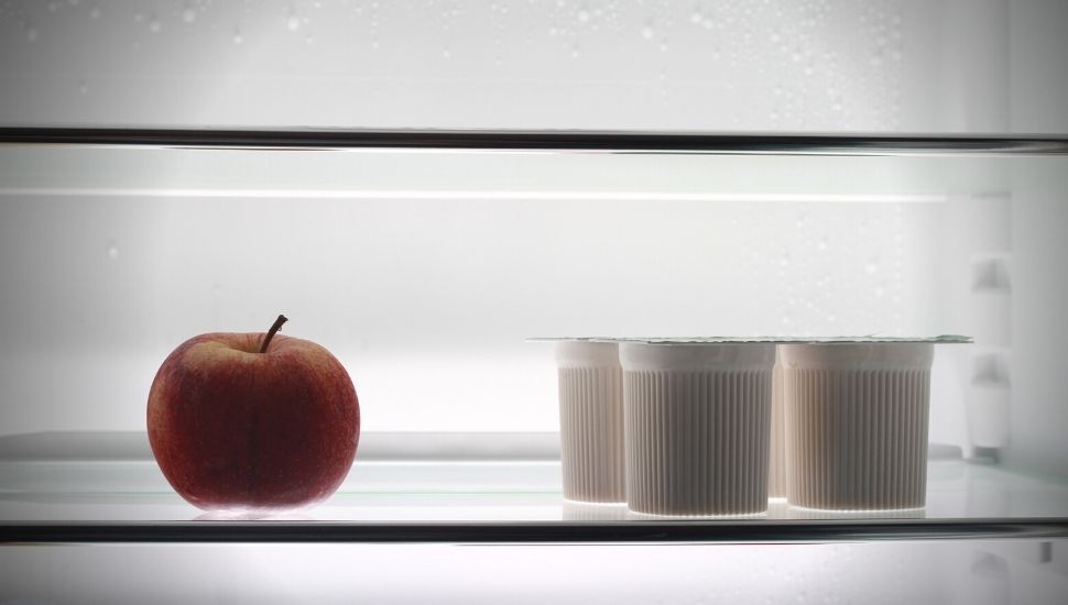 image of Yogurt and an apple in the freezer
