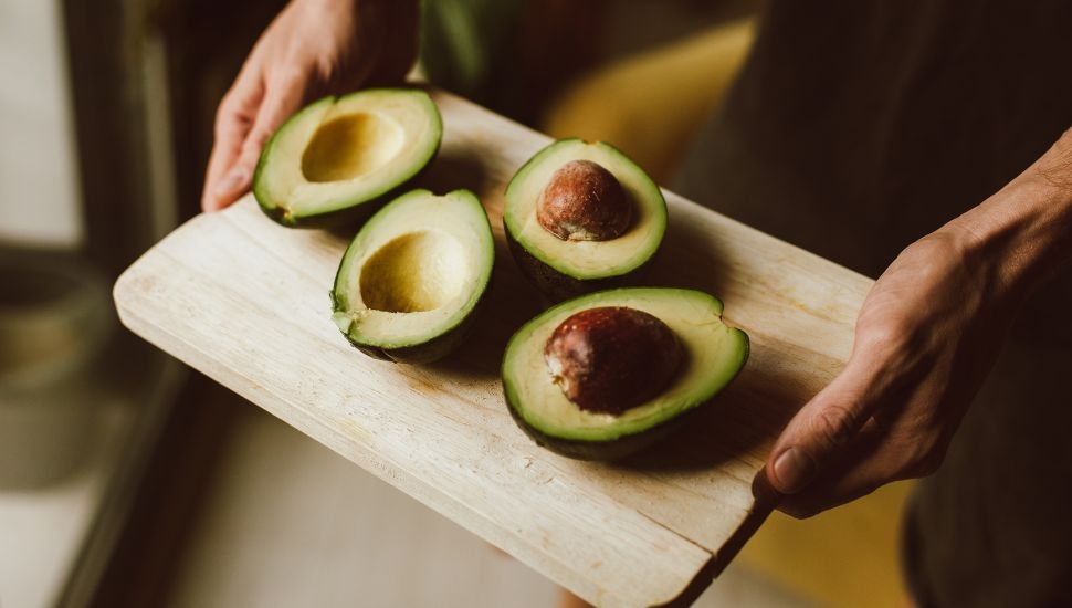 two Avocados sliced in half