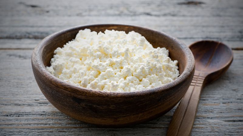 Ricotta Cheese in a wooden bowl and spoon