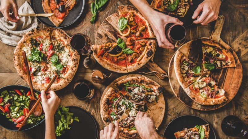 image of four different pizzas in table