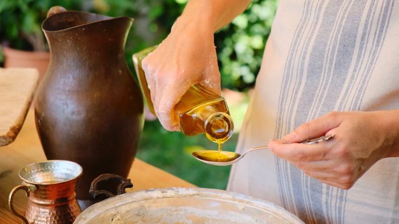 pouring oil on dough