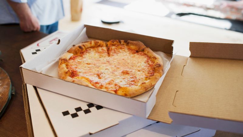 image of cheese pizza in the box