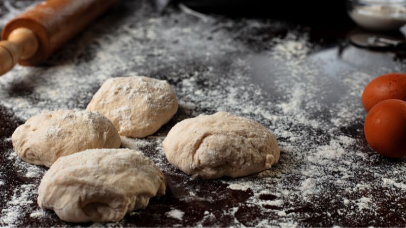 image of four pieces of pizza dough