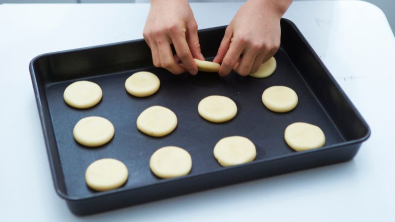 placing cookie dough on baking pan