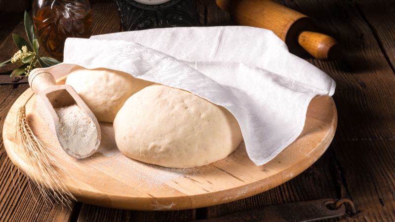 two pieces of dough under a cloth