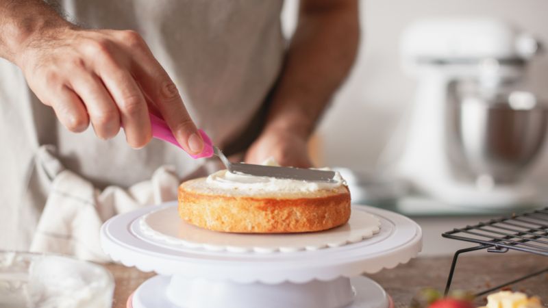 image of a person icing the cake