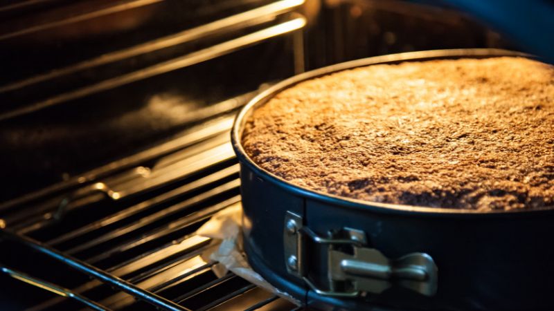 image of cake baking inside oven