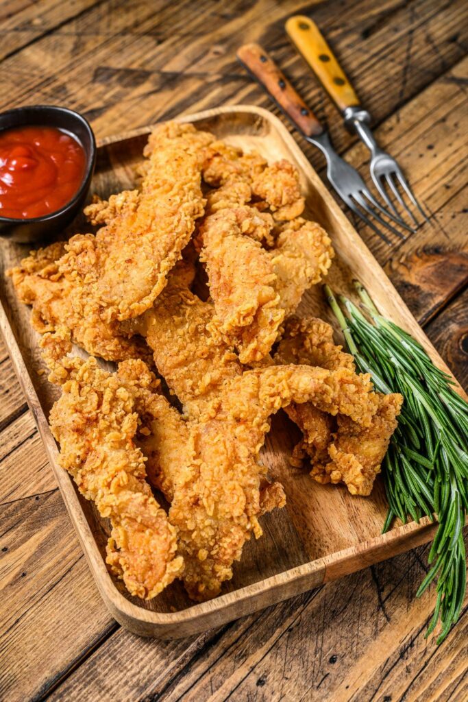 Coconut Chicken Tenders in a wooden plate